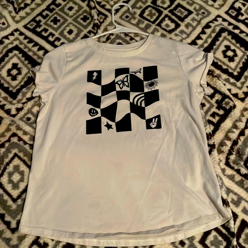 It is a white T-shirt with a square box with different patterns in it